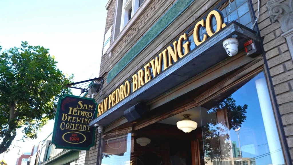 Exterior of San Pedro Brewing Co. building entrance with signage.