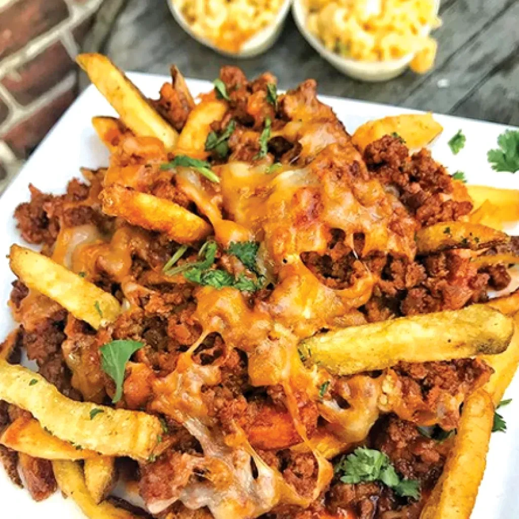 Loaded french fries topped with ground meat, gooey cheese, and cilantro.