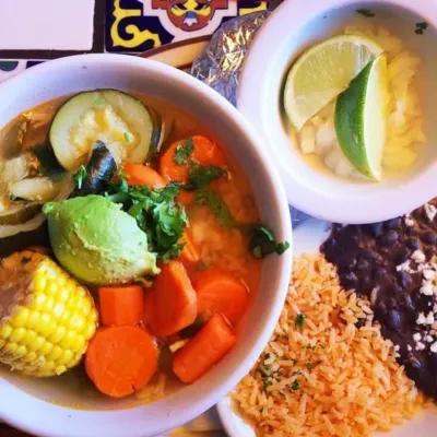 Mexican-style soup with avocado, corn, rice, and black beans.