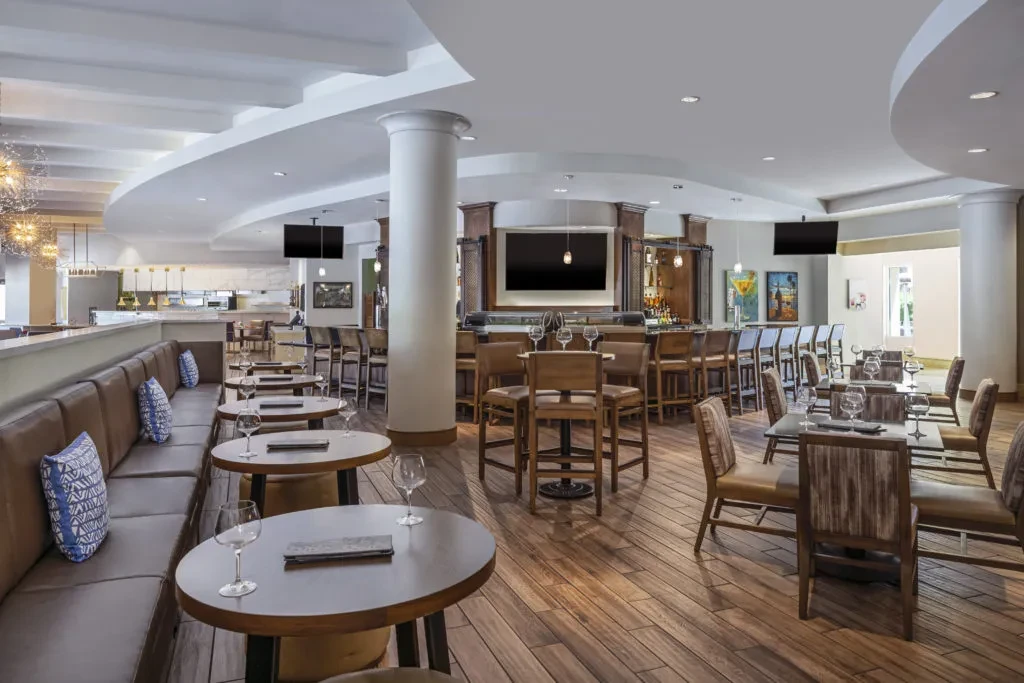 Modern restaurant and bar interior with various seating arrangements.