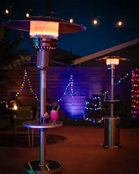 Outdoor patio heater with cocktails and multi-colored string lights.