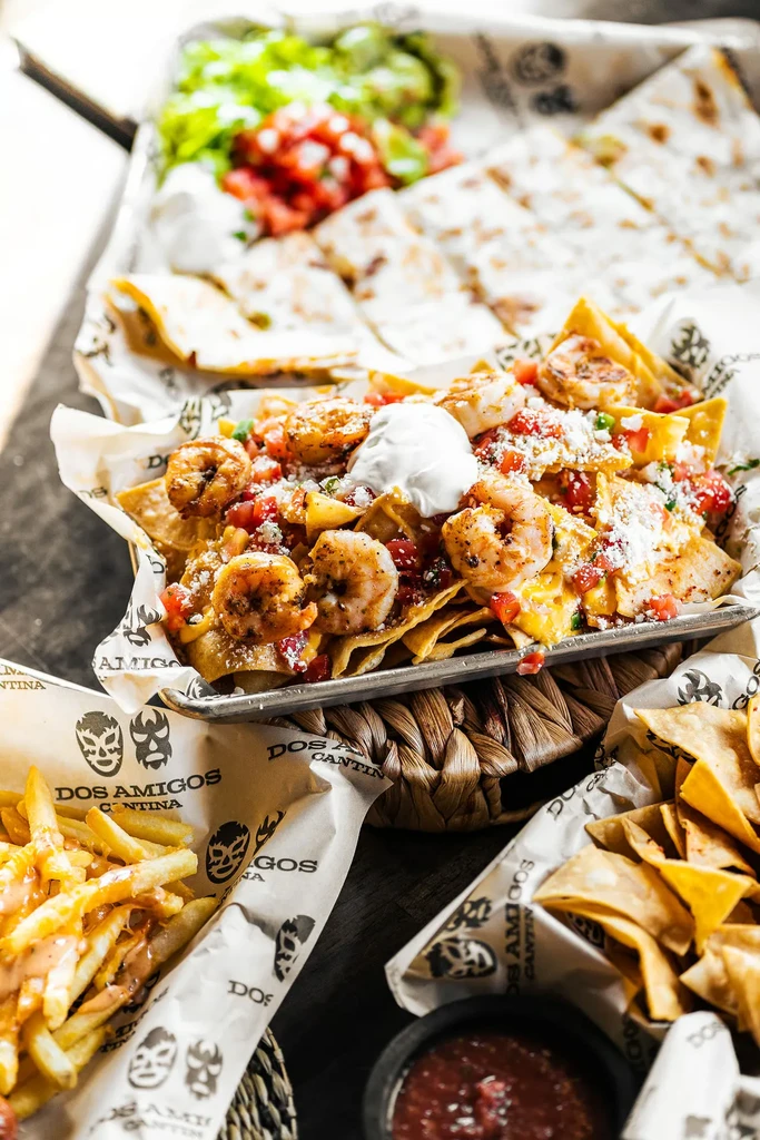 Vibrant photograph of shrimp nachos, quesadillas, and Tex-Mex dishes.