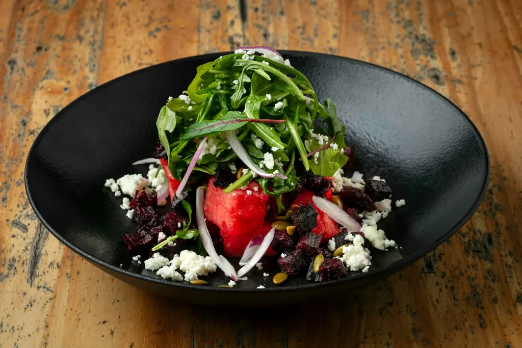 Fresh watermelon, beet, feta, and arugula salad with pepitas.