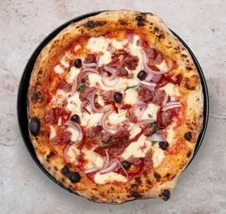 Freshly baked Neapolitan pizza with meat, mozzarella, onion, black olives.