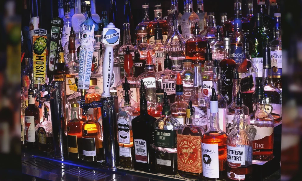 Well-stocked bar with liquor bottles and multiple beer tap handles.