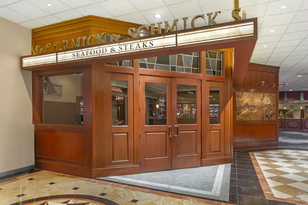 McCormick & Schmick's detailed wooden entrance, marine life relief sculpture.