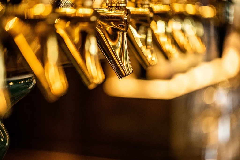 Close-up: golden beer taps, Micro Matic tap in sharp focus.