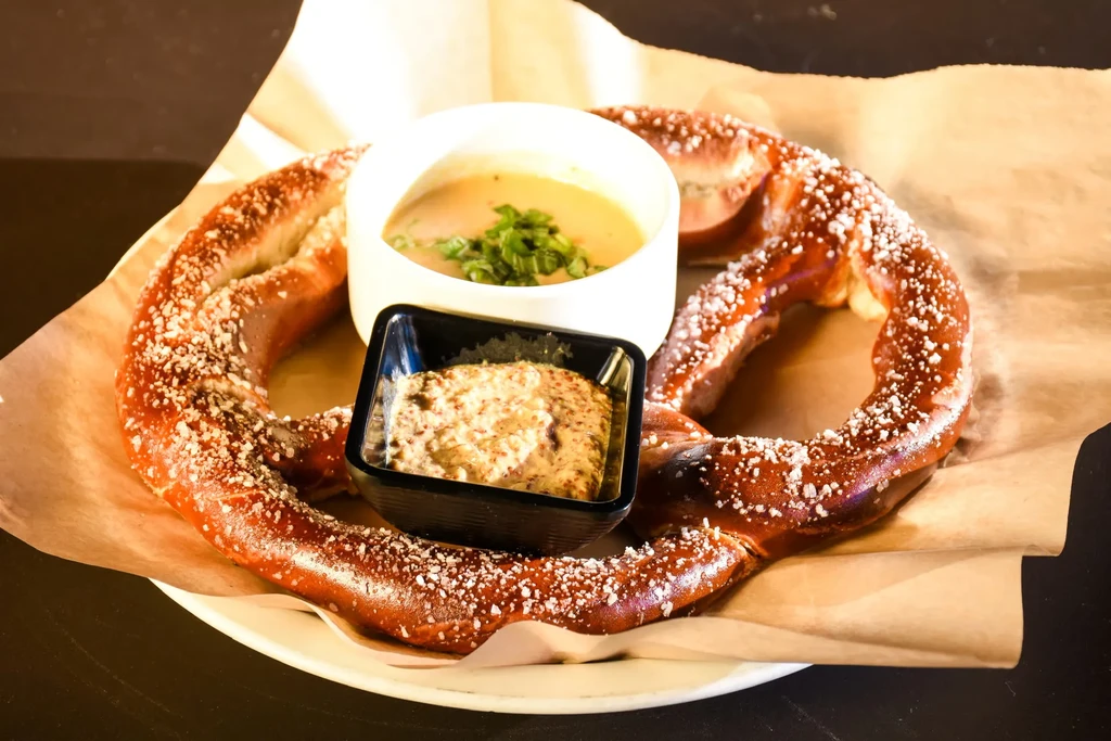 Salted soft pretzel with cheese sauce and whole-grain mustard.
