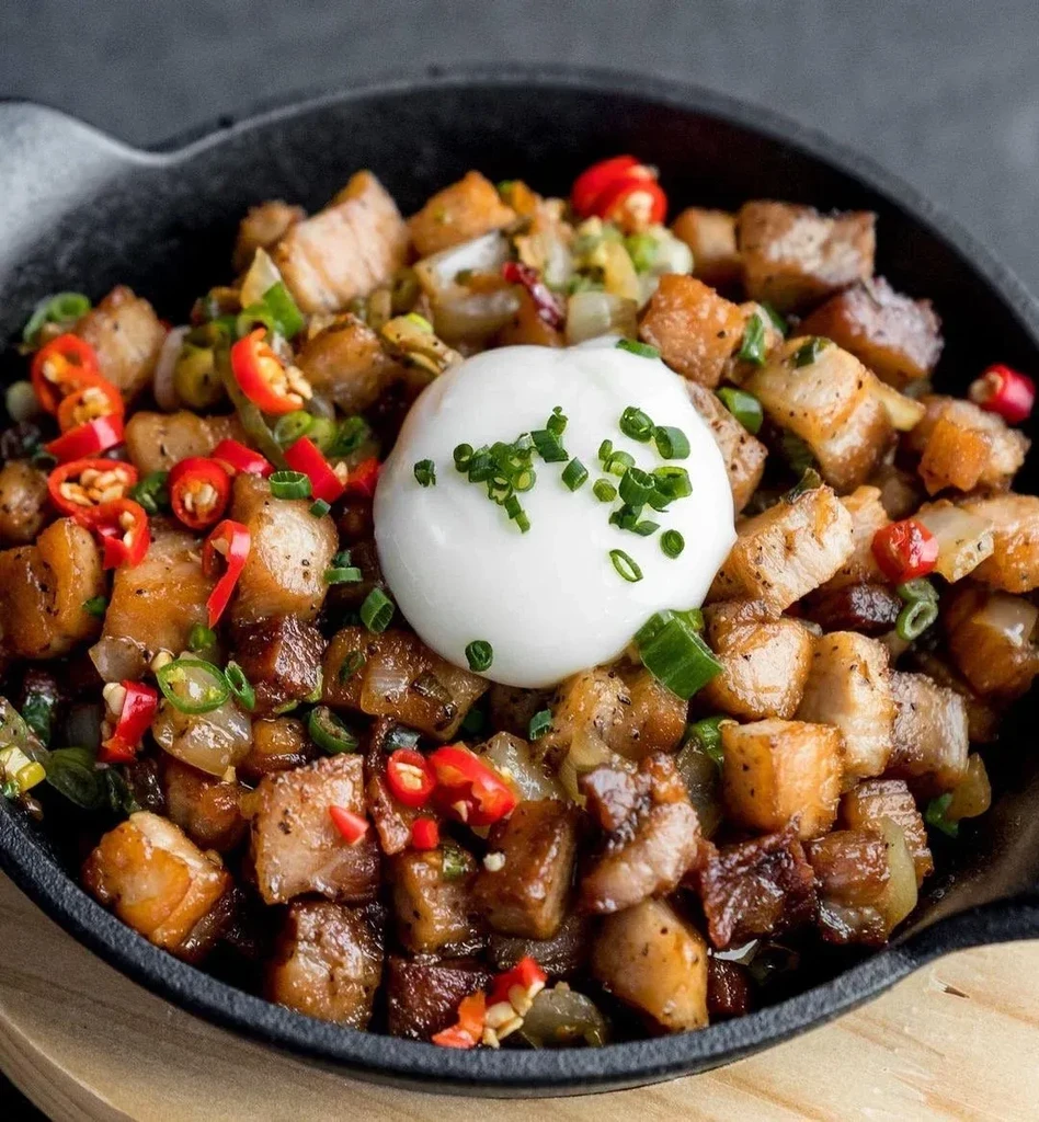 Savory browned meat and vegetables in a skillet with a creamy dollop.