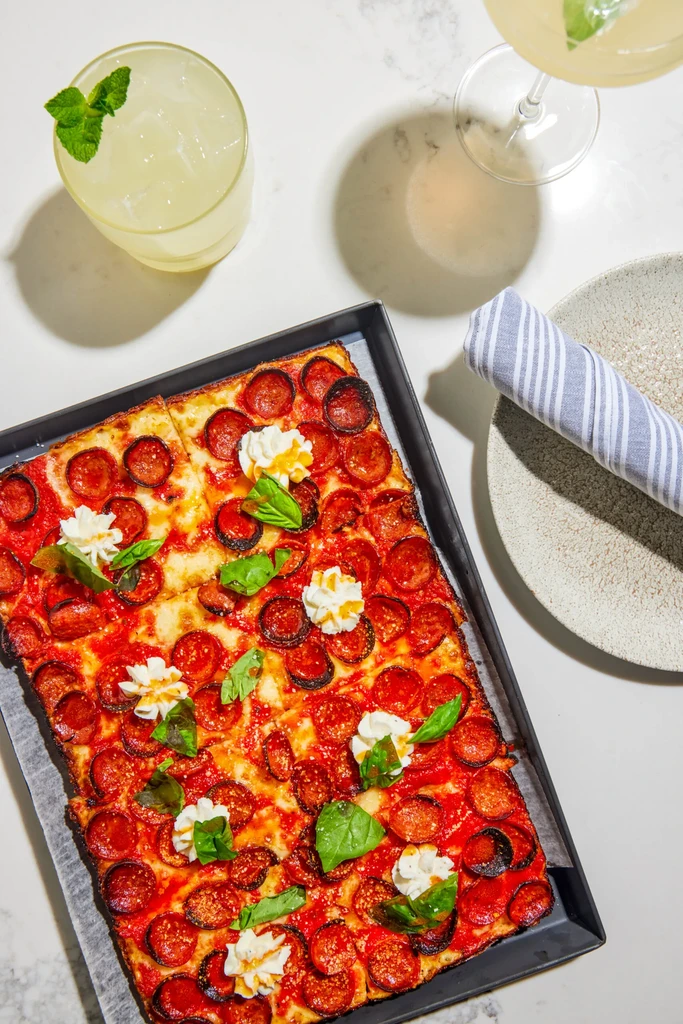 Detroit-style pizza with pepperoni, ricotta, basil, and honey.