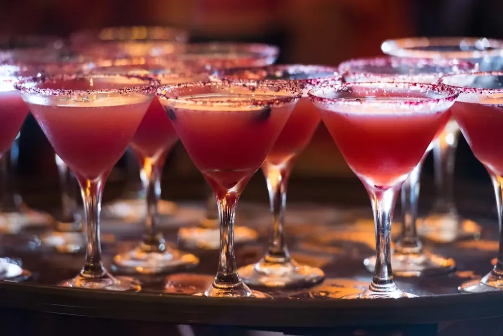 Close-up of pink cocktails in sugared martini glasses.