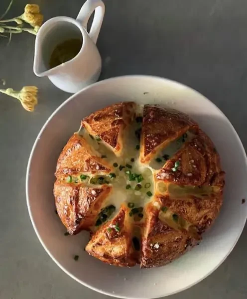Baked dish with creamy white filling and green chives.