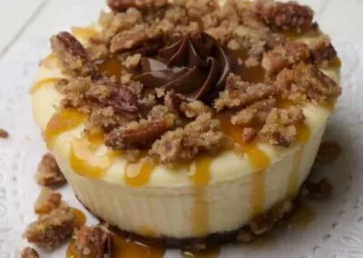 Creamy dessert with caramel, chocolate, pecans, and streusel.