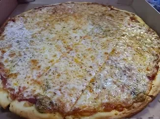 Pre-sliced cheese pizza with melted cheese and herbs in a box.