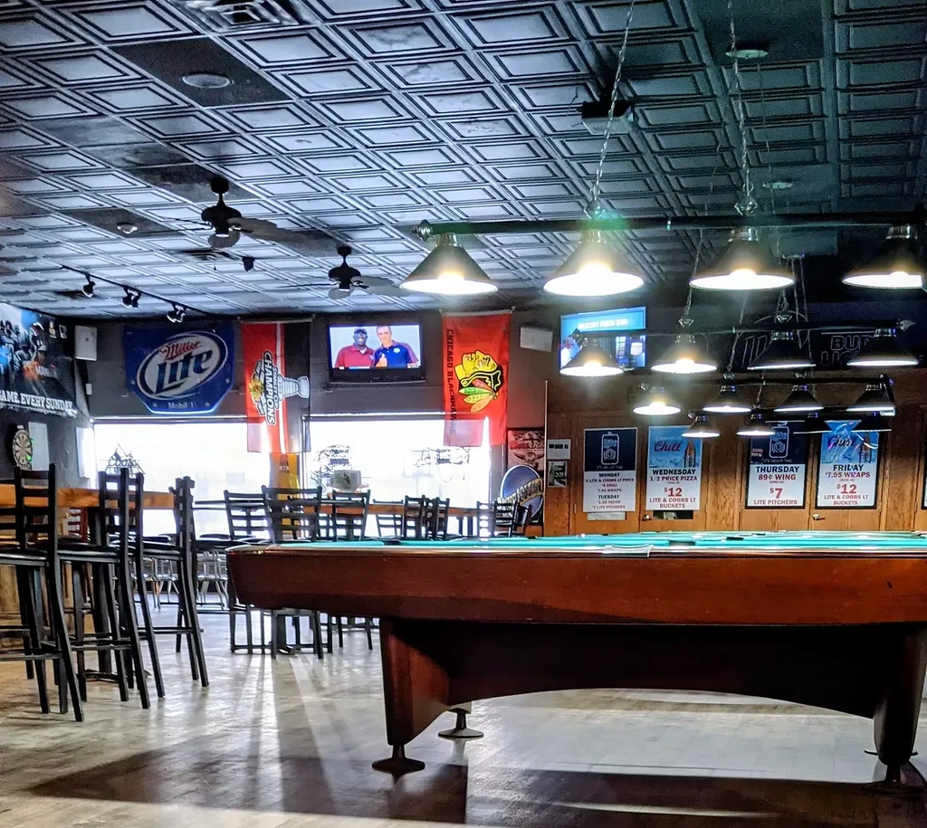 Interior of a sports bar with a prominent blue-felt pool table.