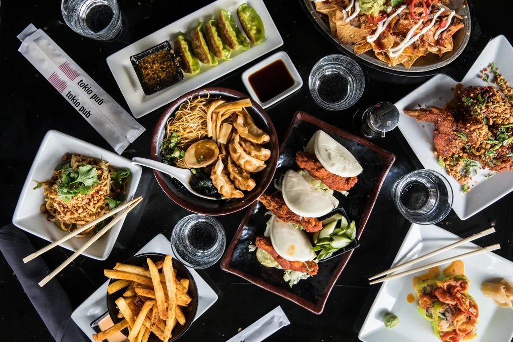 Diverse colorful Asian-inspired dishes and drinks from Tokio Pub.