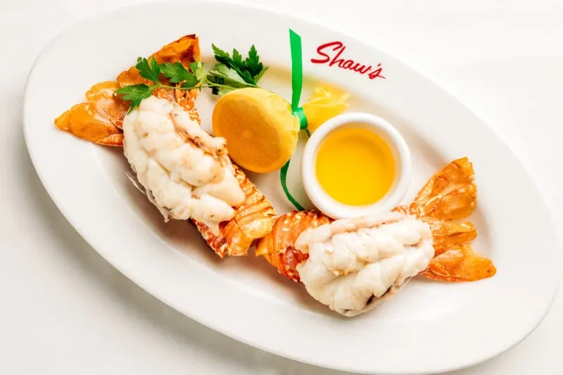 Two lobster tails, lemon, parsley, and melted butter on Shaw's plate.
