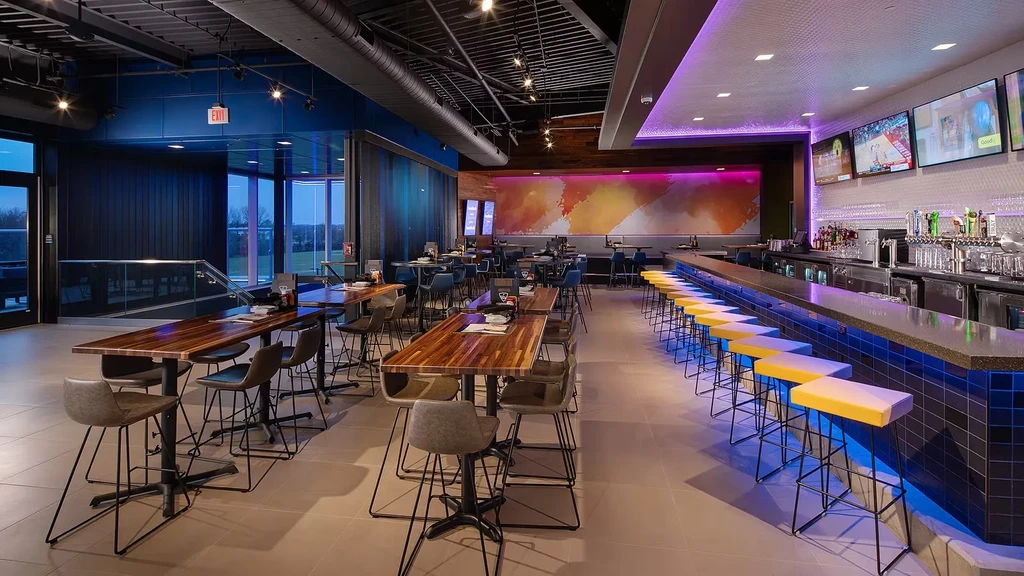 Empty, vibrant, modern restaurant interior with industrial-chic design.