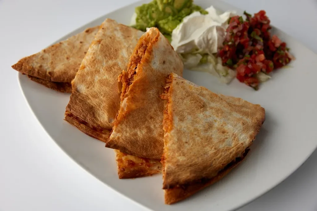 Quesadillas with guacamole, sour cream, and pico de gallo.
