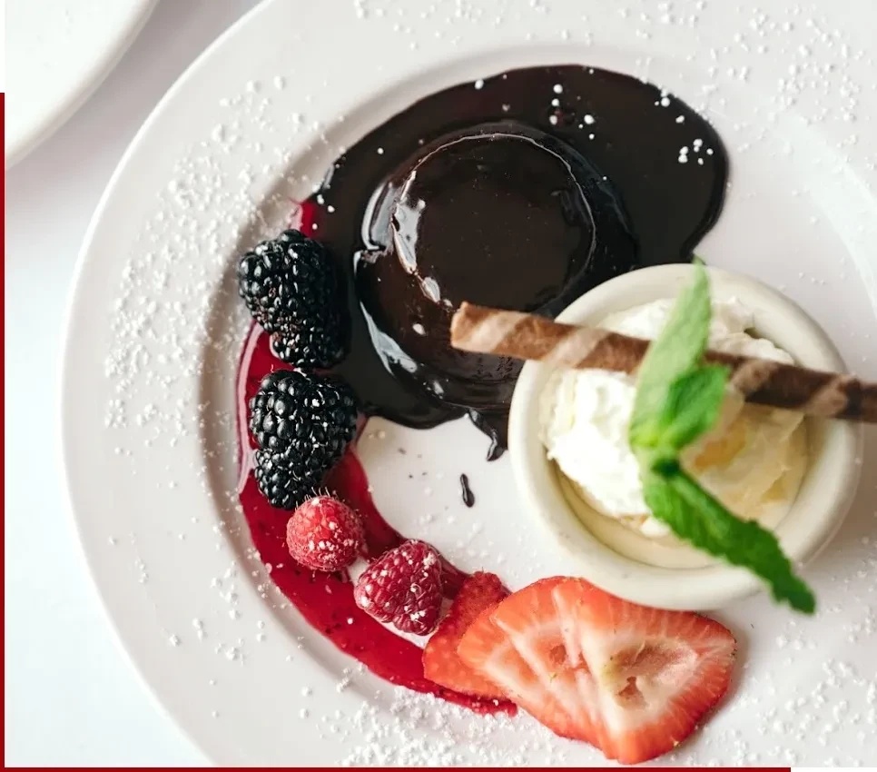 Chocolate lava cake with ice cream, berries, and powdered sugar.
