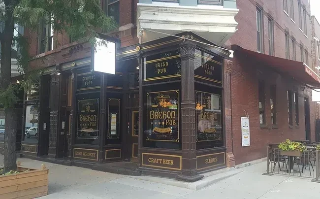 Brebon Pub exterior with outdoor seating on a street corner.