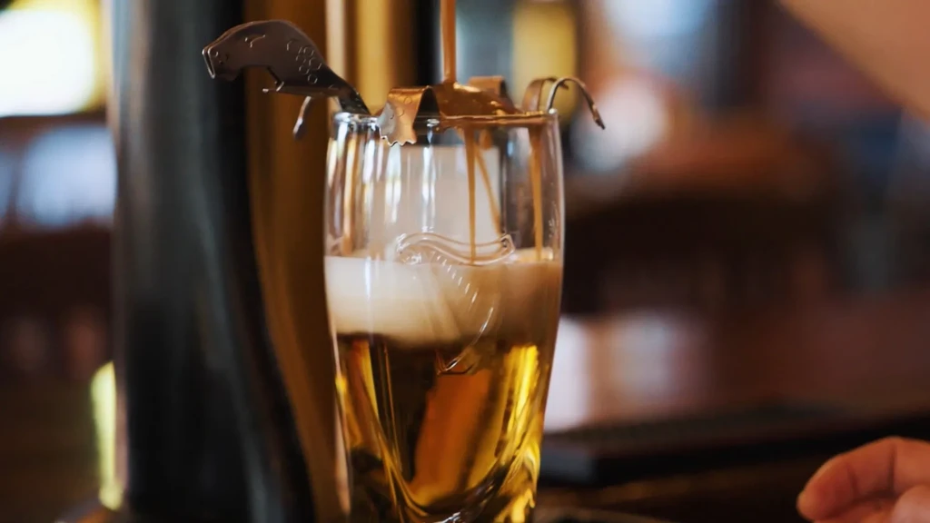 Close-up of a glass being filled with a layered drink.