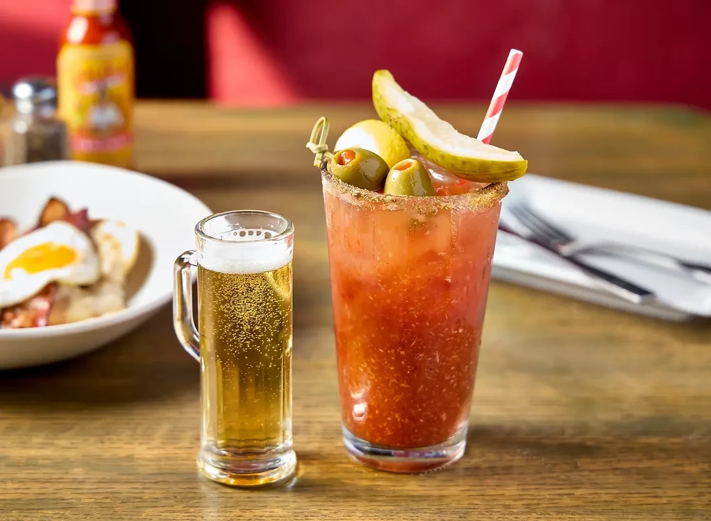 Bloody Mary and beer with breakfast in a restaurant setting.