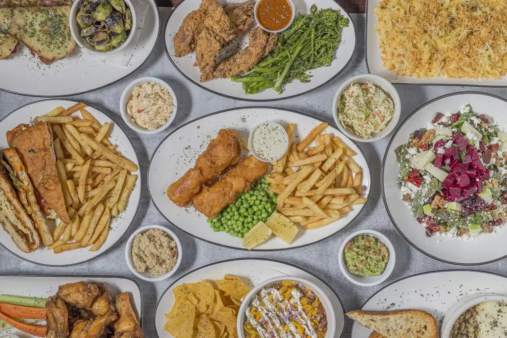 Top-down view of a table spread with various restaurant food dishes.