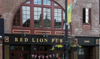 Exterior of Red Lion Pub, brick building with arched window.