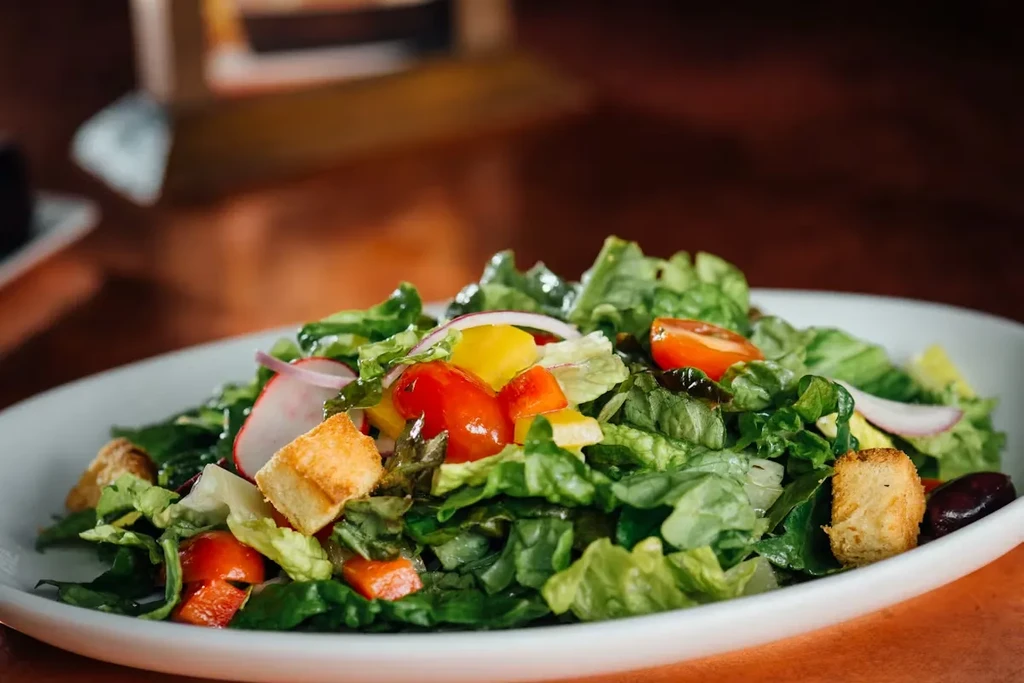 Fresh garden salad with lettuce, tomatoes, bell peppers, and croutons.