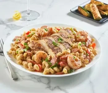 Pasta dish with chicken, sausage, shrimp, and green onions.