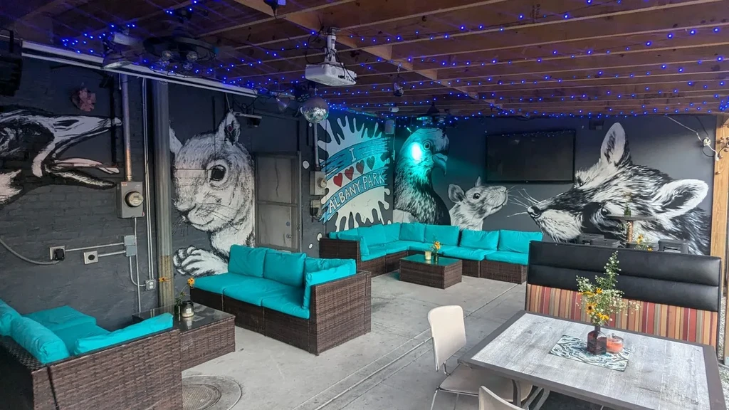 Vibrant bar seating area with animal murals and turquoise cushions.