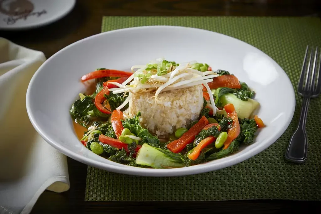 A colorful Asian-inspired rice and vegetable dish in a white bowl.