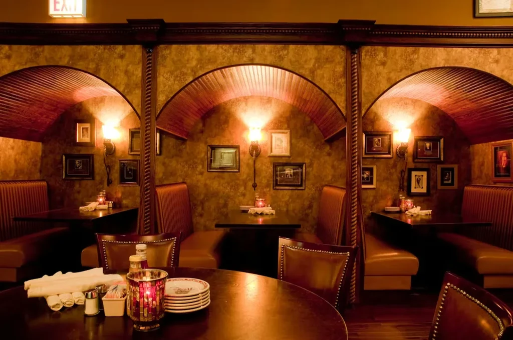 Dimly lit restaurant interior with ornate golden-brown walls and empty booths.