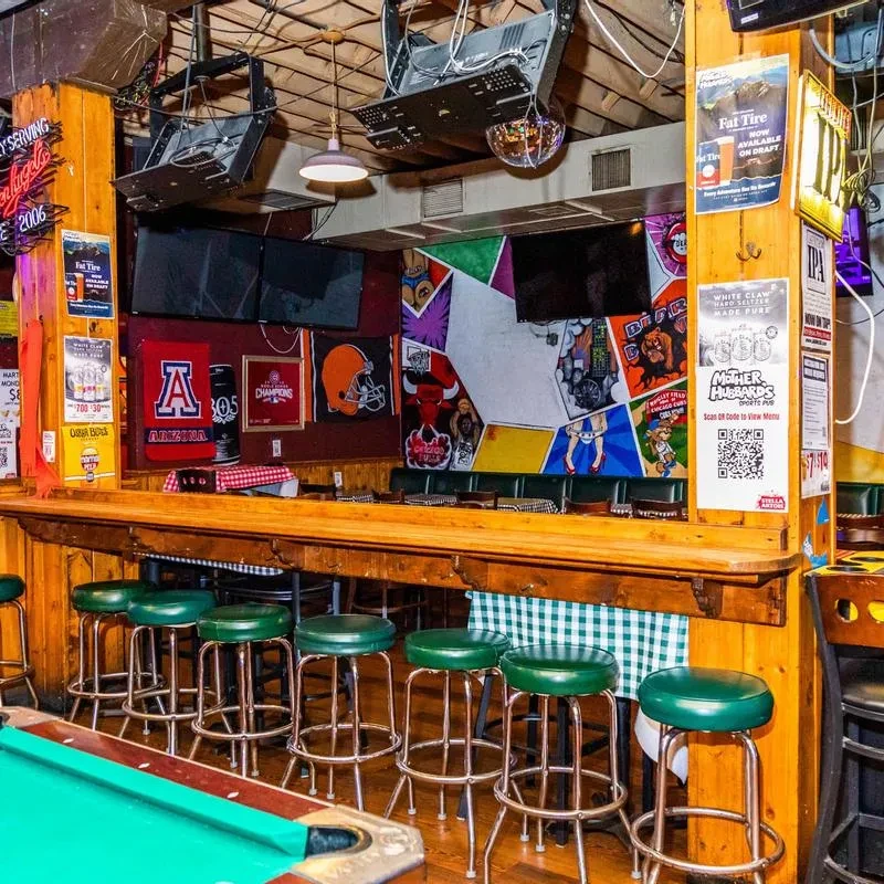 Interior view of a sports-themed bar with a pool table.