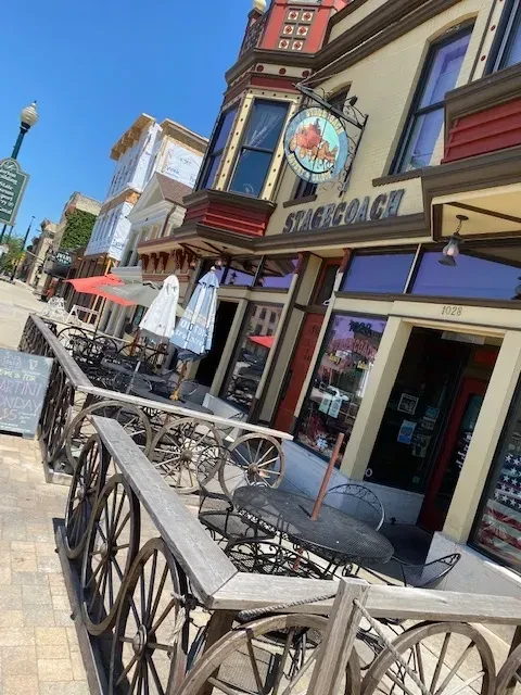 Stagecoach restaurant, yellow walls, red trim, stagecoach sign, outdoor patio.
