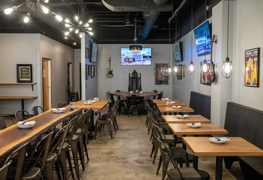 Modern restaurant interior with diverse seating, industrial design, and eclectic decor.