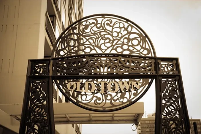 Metal archway with "OLD TOWN" in a circular frame.