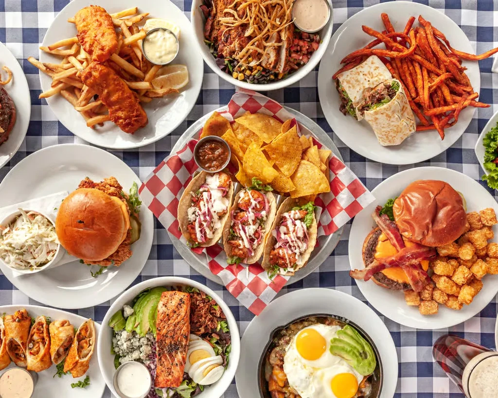 Overhead view of a table filled with various diner-style meals.