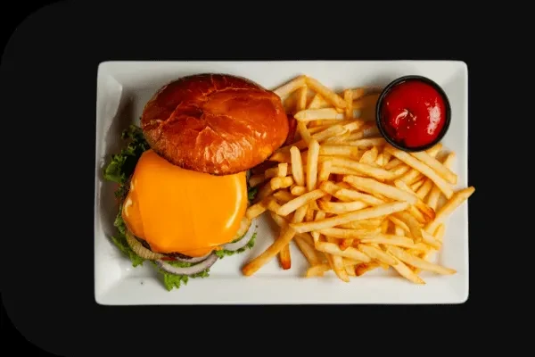 Cheeseburger with fries and ketchup on a white plate.