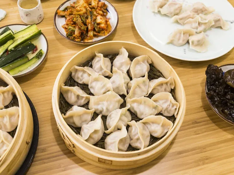Overhead view of a table filled with various Chinese dumpling dishes.