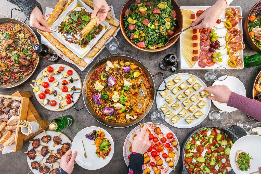 Overhead view of a large table laden with a variety of dishes.