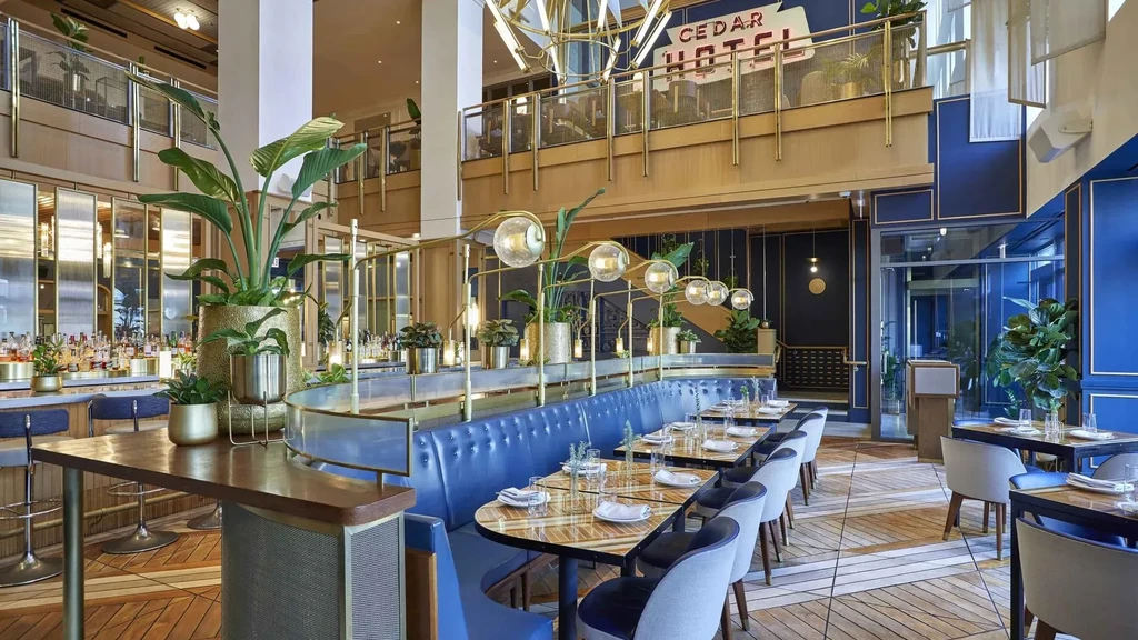 Interior of Cedar Hotel bar and dining area with blue banquettes.