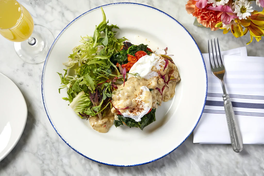 Overhead shot of a beautifully plated meal with poached eggs and salad.
