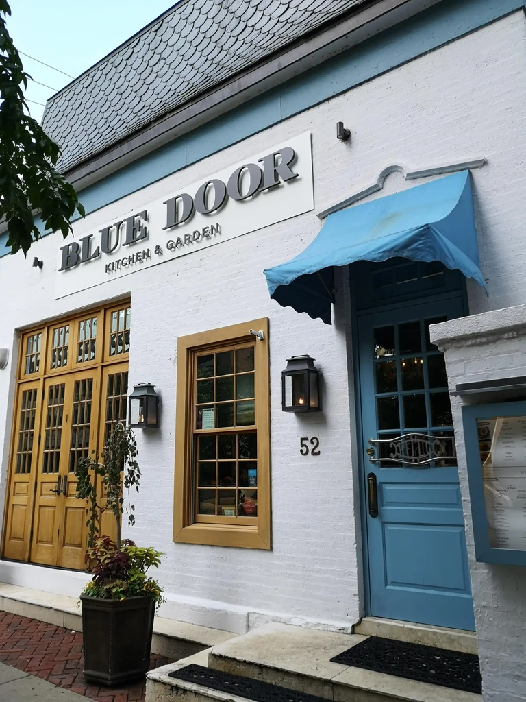 Exterior of BLUE DOOR KITCHEN & GARDEN restaurant building.