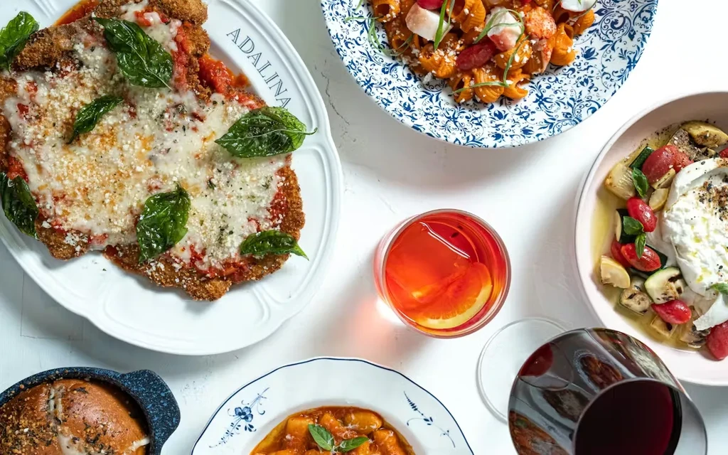 Overhead shot of an Italian meal spread on a white table.