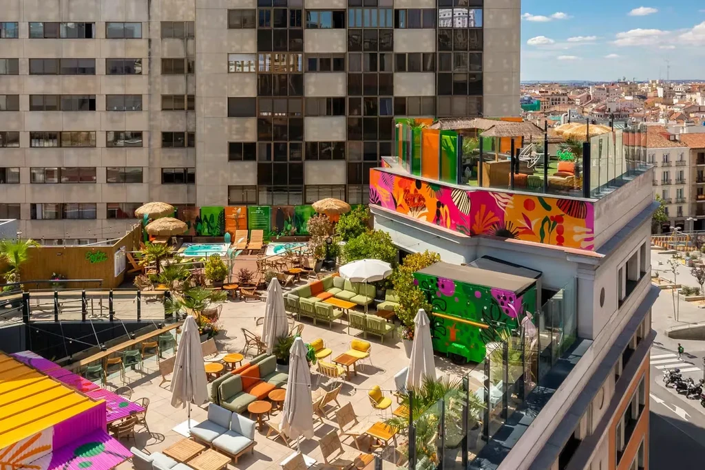 Rooftop bar and lounge with pool in a vibrant city setting.