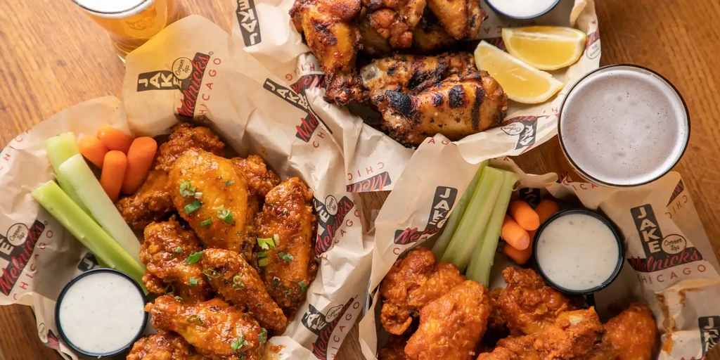 Overhead shot of two baskets of chicken wings and beer.