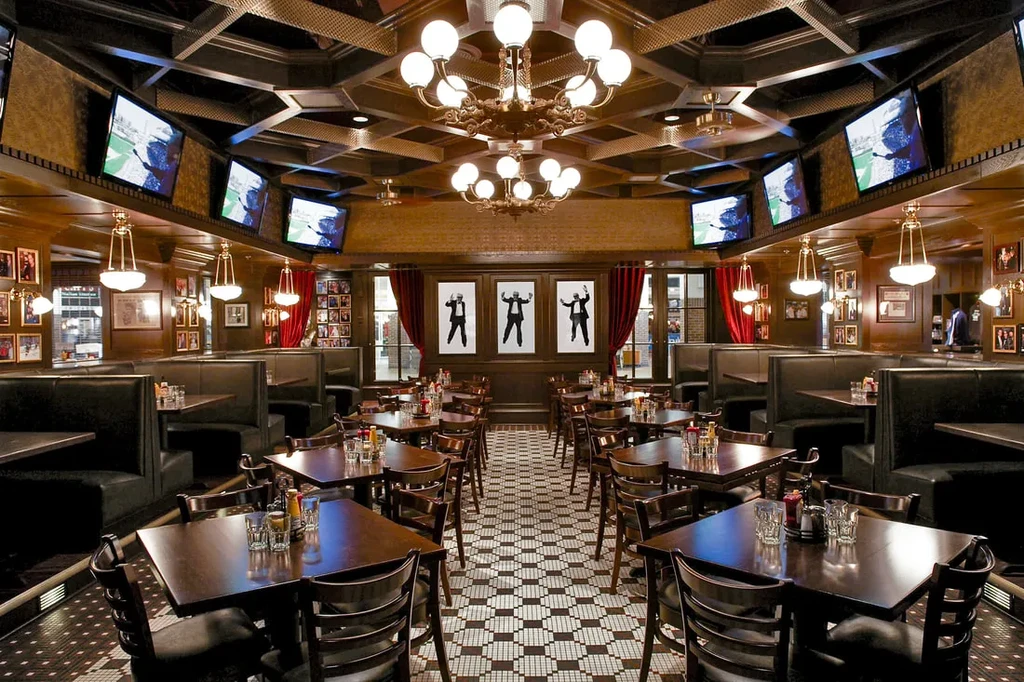 Restaurant interior with dark wood, ornate chandeliers, and geometric tile.