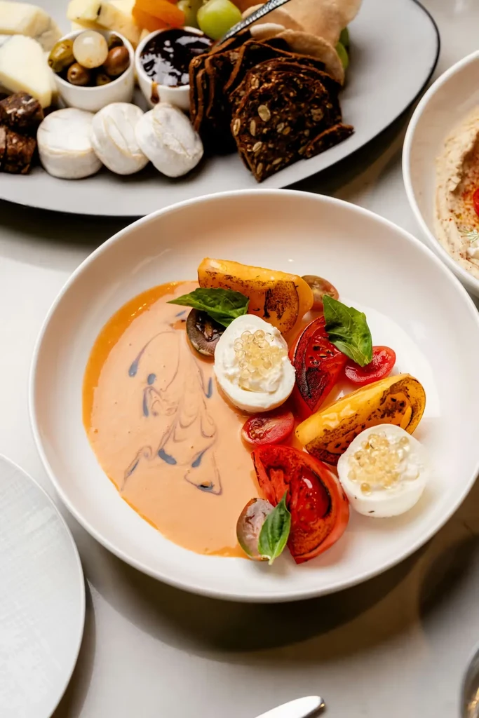 High-angle close-up of a caprese salad in a white bowl.